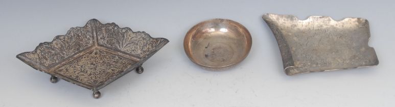 A Middle Eastern silver coloured metal filigree lozenge shaped dish, ball feet, 18cm wide, 160g; a