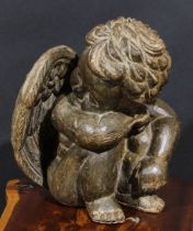 A Continental sculptural carving, of a seated putto, 36cm high