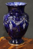 A Royal Doulton stoneware ovoid vase, by Maud Bowden, in relief with ribbon-tied swags and pendants,