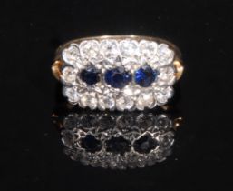 A diamond and sapphire cluster ring, rounded rectangular crest set with three blue sapphires