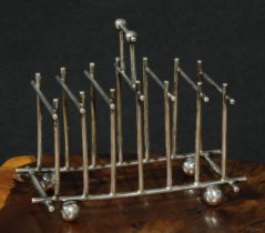 An Aesthetic Movement silver seven-bar toast rack, in the manner of Dr Christopher Dresser, posted