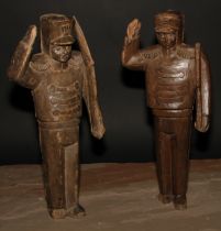 Folk Art - a pair of carved figures, Napoleonic soldiers, each standing to attention, 41cm high,