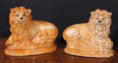 A pair of 19th century Staffordshire mantel lions, glass eyes, 24.5cm high