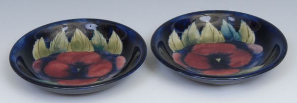 A pair of Moorcroft Pansy pattern circular dishes, tube lined on a mottled blue ground, 18.5cm