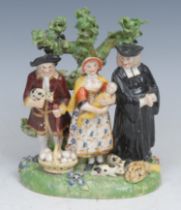 A Derby porcelain Tythe Pig group, with a farmer, his wife and a clergyman with basket of eggs,