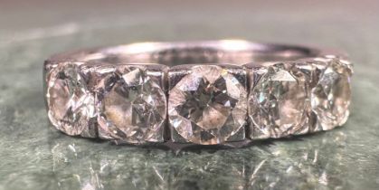 A diamond ring, linear set with five round brilliant cut diamonds, total estimated diamond weight