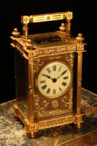 A late 19th century French gilt brass carriage timepiece, 4.5cm enamel clock dial, on a tooled and