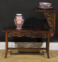 A Chinese hardwood porcelain and sculpture stand, the frieze carved with a dragon and bats, 73cm