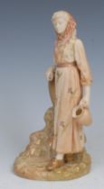 A Royal Worcester blush ivory figure, of a female water carrier, 16cm high, printed crown and circle