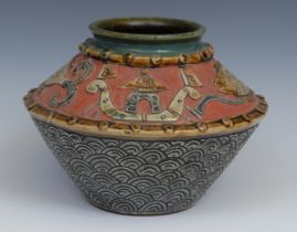 A studio pottery vase, decorated in the typical Japanese manner with stylised fish and figures on