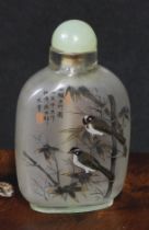 A Chinese inside painted flattened ovoid snuff bottle, decorated with verse, and birds amongst
