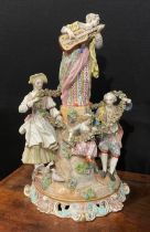 A continental porcelain figure group, of a gentleman and his companion draped in a floral