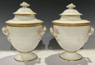 A pair of 19th century porcelain ice pails, in the white and picked out in gilt, each with covers