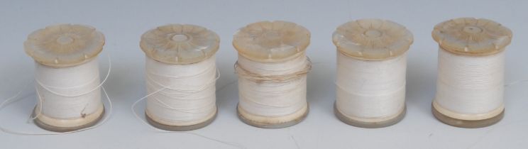 A set of five 19th century mother of pearl cotton reel bobbins, each carved as a lotus, 3.5cm