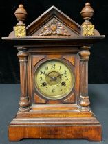 A Victorian walnut cased mantel clock