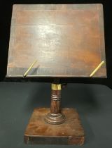 A 19th century mahogany table top book rest or music stand, the rectangular tilt top plateau cross