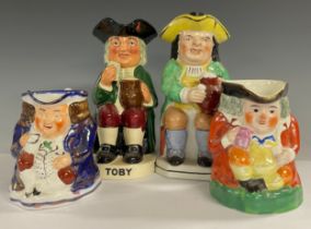 A Victorian Staffordshire Toby jug, seated holding a jug of foaming ale wearing Salmon britches,