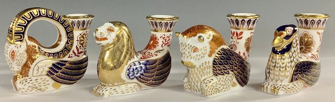 A set of four Royal Crown Derby Mythical Beast Candlesticks, Winged Griffin, Winged Ram, Winged Bull