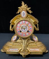 A 19th century French gilt mantel clock, set with porcelain panels, eight day movement, H T Brevet