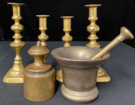 A pair of 19th century brass candlesticks, knopped pillars, one multi-faceted, sloped square