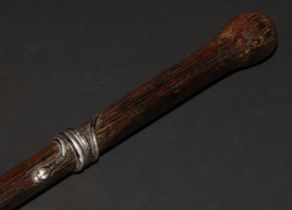 An early 20th century silver coloured metal mounted palmwood walking stick, the cane entwined by a