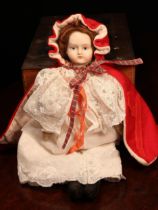 A bisque shoulder head doll, the bisque shoulder head with painted features including brown