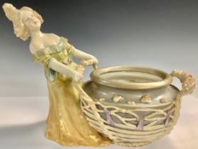 An Austrian Art Nouveau porcelain figural vase or table centre, modelled as a young girl with an