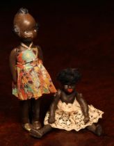 An early 20th century black composition jointed doll, painted features, black flock type hair, 9cm