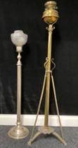 A brass lamp stand with Duplex burners and a tripod base, each terminating with a mask; a steel