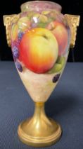 A Staffordshire porcelain two handled pedestal vase in the manner of Royal Worcester, painted with