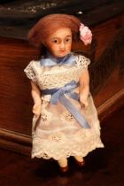 A French bisque head and jointed painted composition bodied doll, of small proportions, the bisque