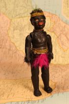 An early 20th century black composition jointed doll, painted features, black flock type hair,