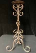 A planished and wrought copper pricket stick, 70cm