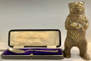 A Bronze bear money box, 15cm, c.1880; a George v silver spoon, Sheffield 1919, cased (2)