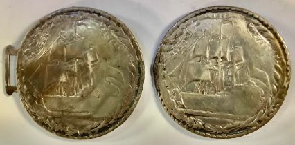 A silver buckle, sailing ships
