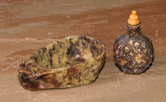 A Chinese soapstone libation cup, carved with blossoming prunus, 10.5cm wide; a snuff bottle, 7cm