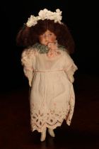 An early 20th century bisque shoulder head doll, probably English, the bisque shoulder head with