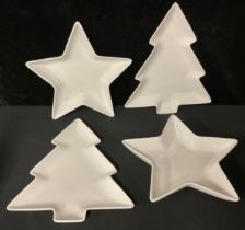 A pair of Christmas tree shaped serving plates, 29cm; a similar pair of star shaped serving/party