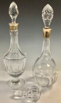 A continental cut glass decanter, drop-in stopper, the silver collar marked 925; another similar,