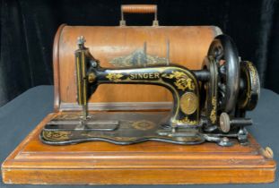 An Edwardian Singer hand cranked sewing machine, cased