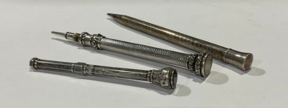 A Victorian silver propelling pencil, Birmingham hallmarks; another, silver coloured metal; an