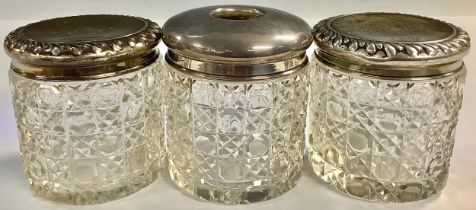 A pair of silver lidded hobnail cut dressing table jars; a siler topped hair tidy (3)