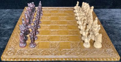 A novelty Studio Anne Carlton chess set, The American War of Independence, moulded resin chess