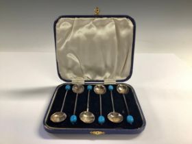 A set of Art Deco silver coffee spoons, blue bean terminals, Birmingham 1932, cased