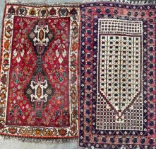 A Middle Eastern rectangular woollen rug or carpet, stylised geometric shapes, in tones of red, blue