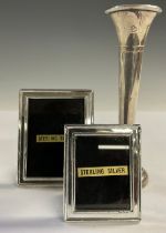 An Elizabeth II silver specimen vase, Birmingham 1977; two small silver easel photograph frames (3)