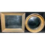 An early 20th century gilt framed circular bullseye looking glass; another, gilt framed