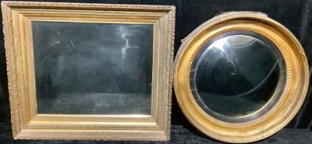 An early 20th century gilt framed circular bullseye looking glass; another, gilt framed