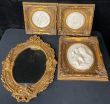 A reconstituted marble oval plaque in relief, after the antique, ornate giltwood frame, 36.5 x 31.