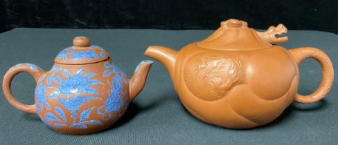 A Chinese Yixing teapot, articulated head of a dragon; a teapot with blue enamel decoration